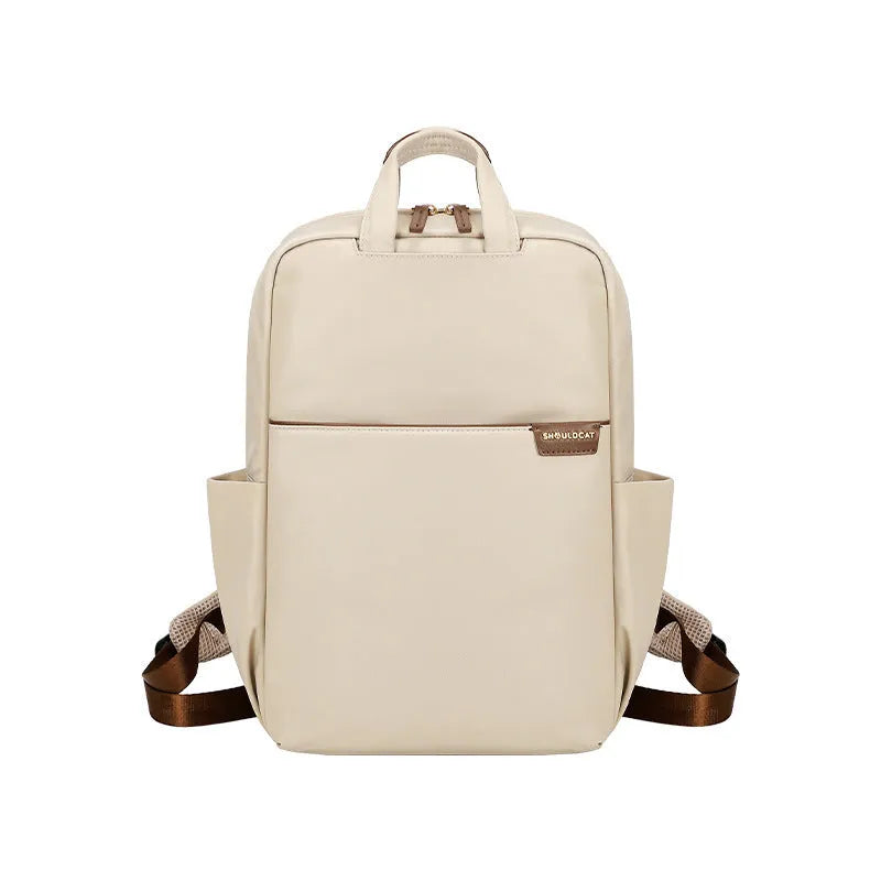 Women's canvas travel backpack in apricot colour showing multiple internal compartments including laptop section