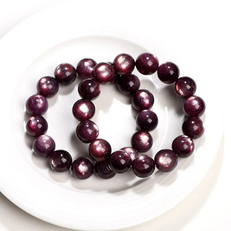 Purple lepidolite crystal round bead bracelet with polished finish on a wrist.