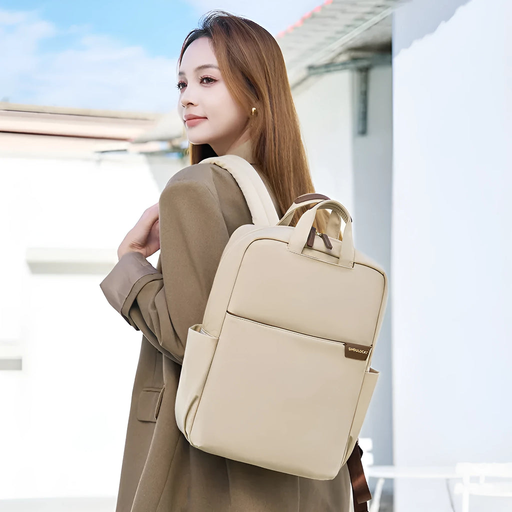 Women's canvas travel backpack in apricot colour showing multiple internal compartments including laptop section