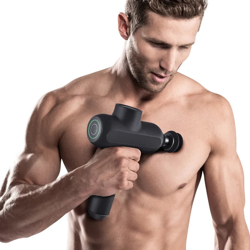 Black electric muscle massager with six removable heads showing five-speed control button