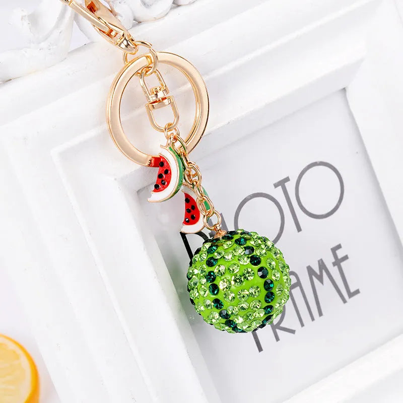 Green watermelon-shaped zinc alloy keychain measuring 12 cm in length