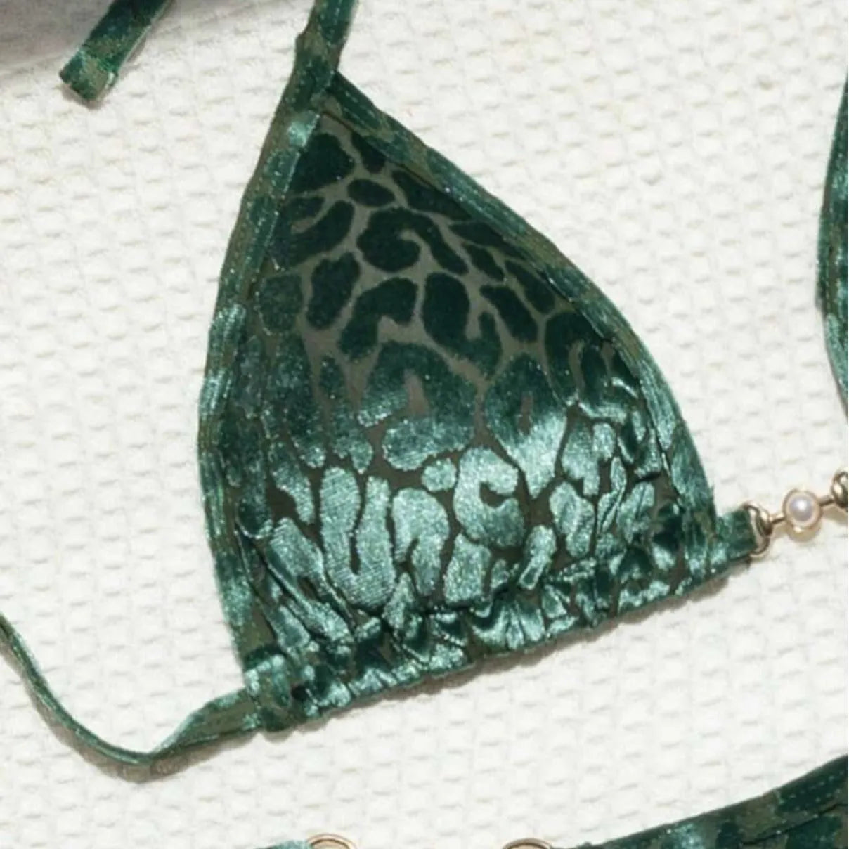 Women's T-shaped leopard print bikini swimsuit in polyester and spandex fabric on a mannequin.