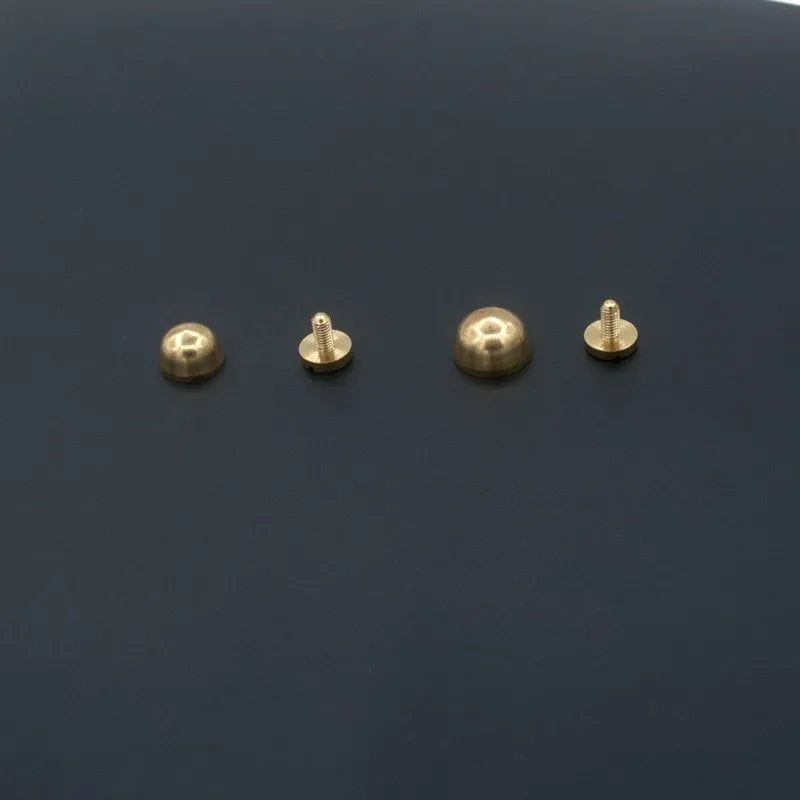 Brass decorative buckle foot nails in round and bucket head shapes, sizes 10x6mm and 12x7mm.
