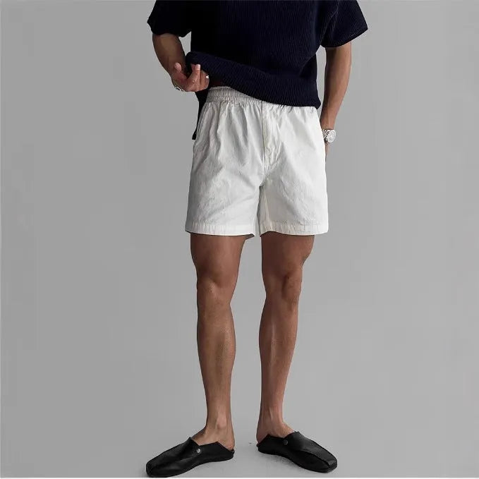 Men's cotton sports shorts in loose fit style available in black, white, and khaki colours