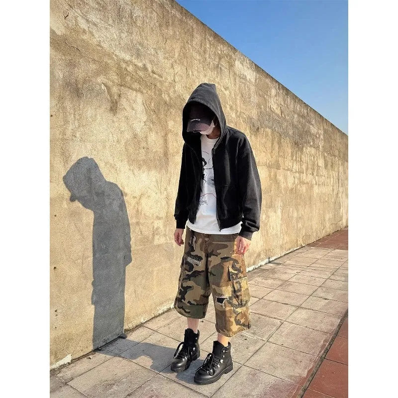 Men's loose-fit camouflage cropped jeans with ripped knee detailing, shown in a straight-leg silhouette.