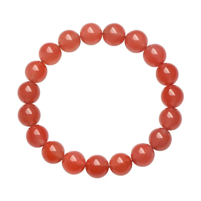 Natural South cherry red agate bracelet showing polished stone beads in scattered arrangement