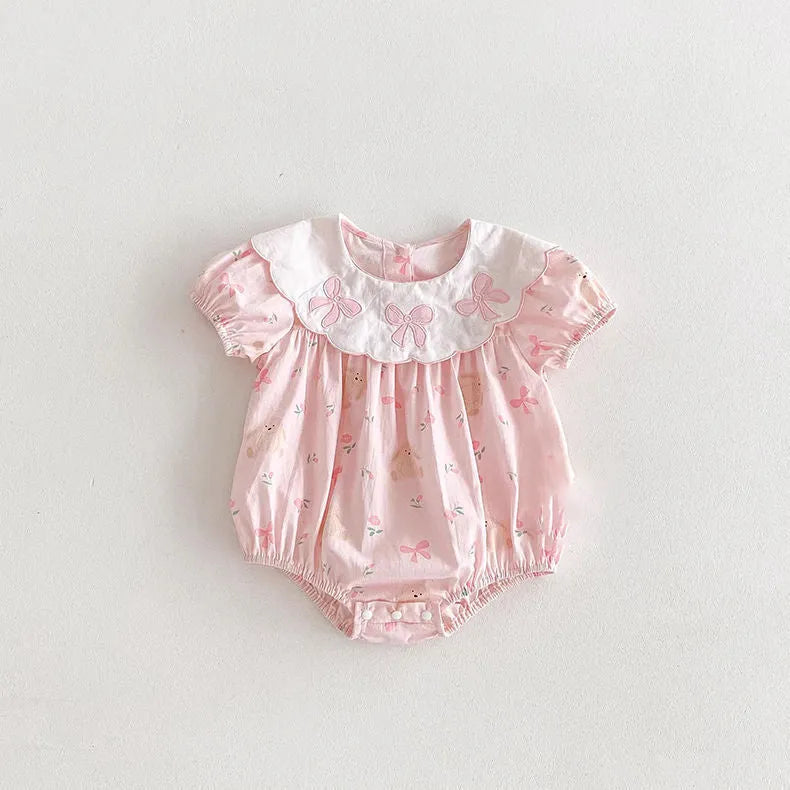 Pink cotton triangle romper jumpsuit for baby girl with three bow details, short sleeves, suitable for height 66-90cm