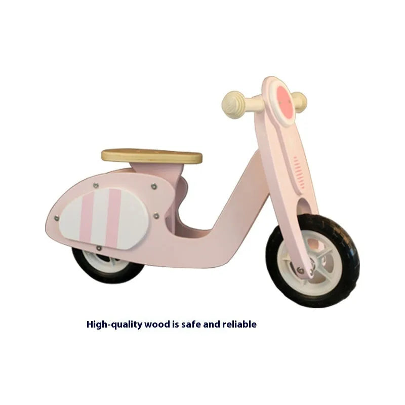 Pink wooden balance scooter for toddlers and young children on a 10-inch wooden deck.