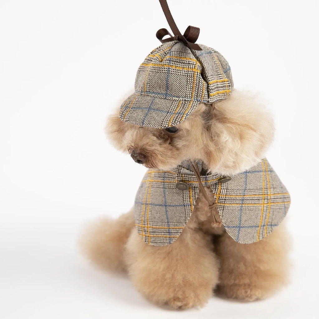 Camel coloured cotton detective cloak for dogs on a hanger, showing the adjustable hat.