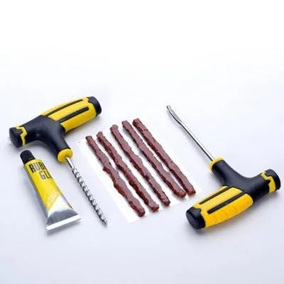 Black and yellow 8-piece vacuum tyre repair tool kit with rubber strips, glue, and metal tools on plastic packaging.