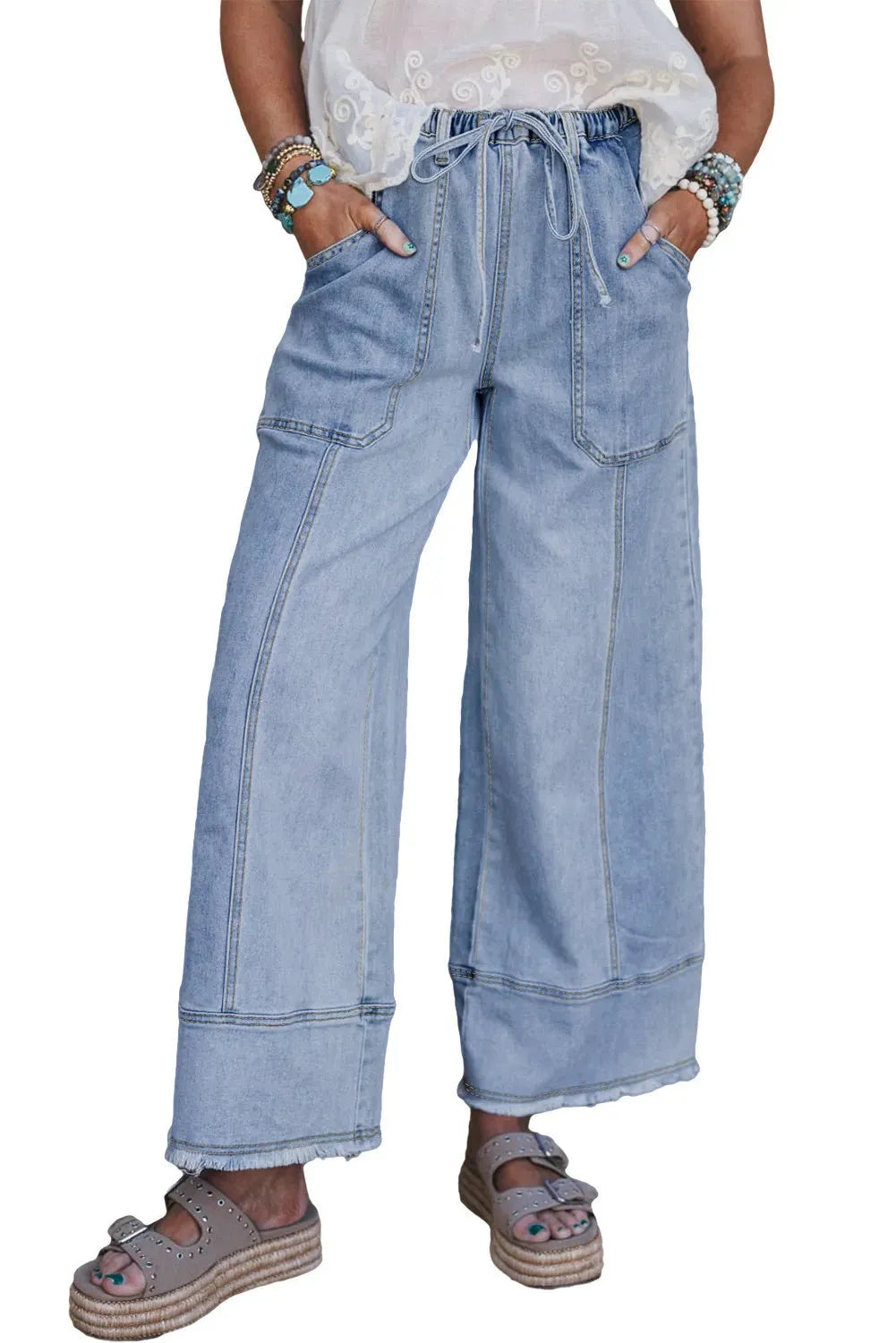 Beau blue wide-leg women's denim trousers with an elasticated drawstring waist and raw hem seam detail laid flat.