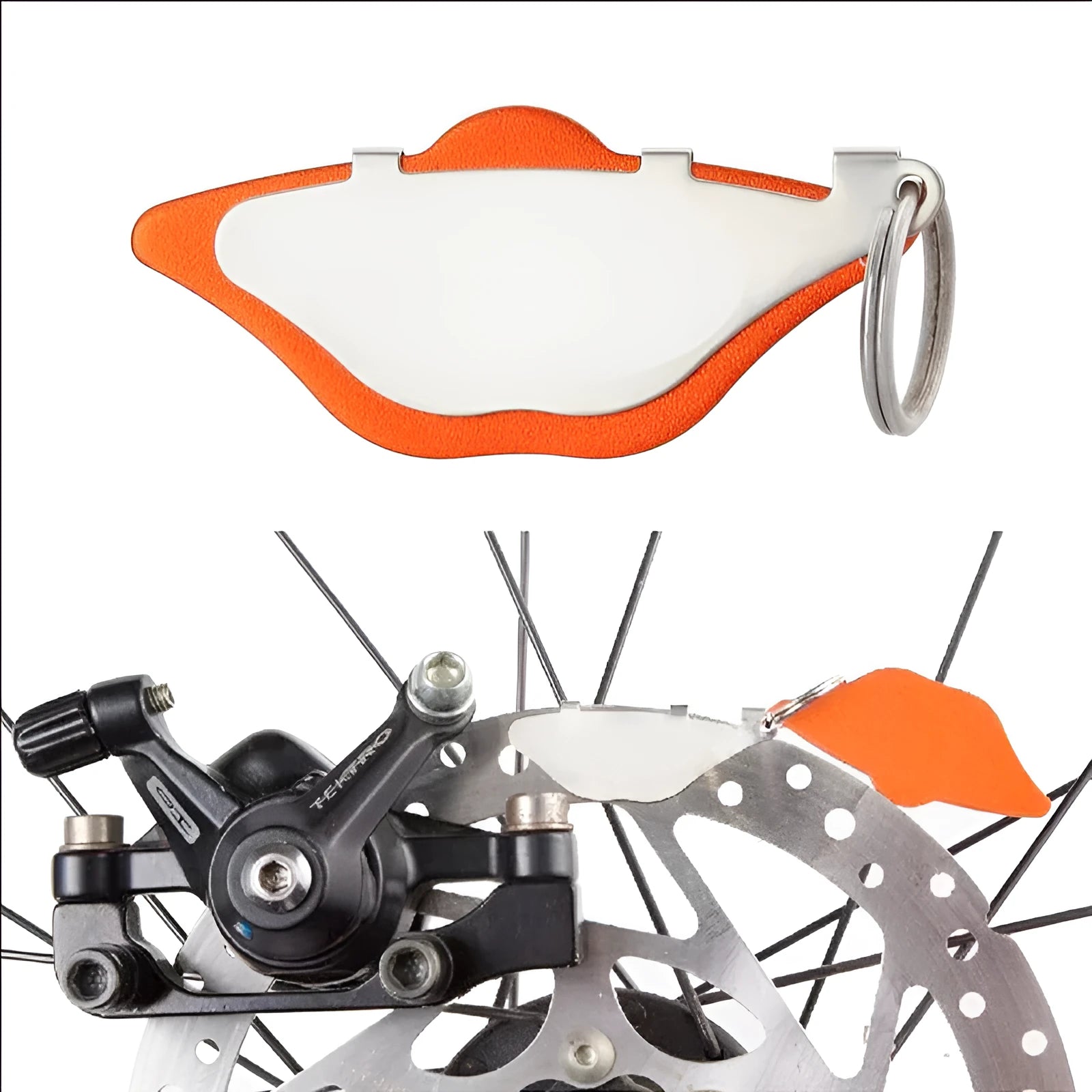 Black and orange metal mountain bike disc brake pads with an adjustment flap.