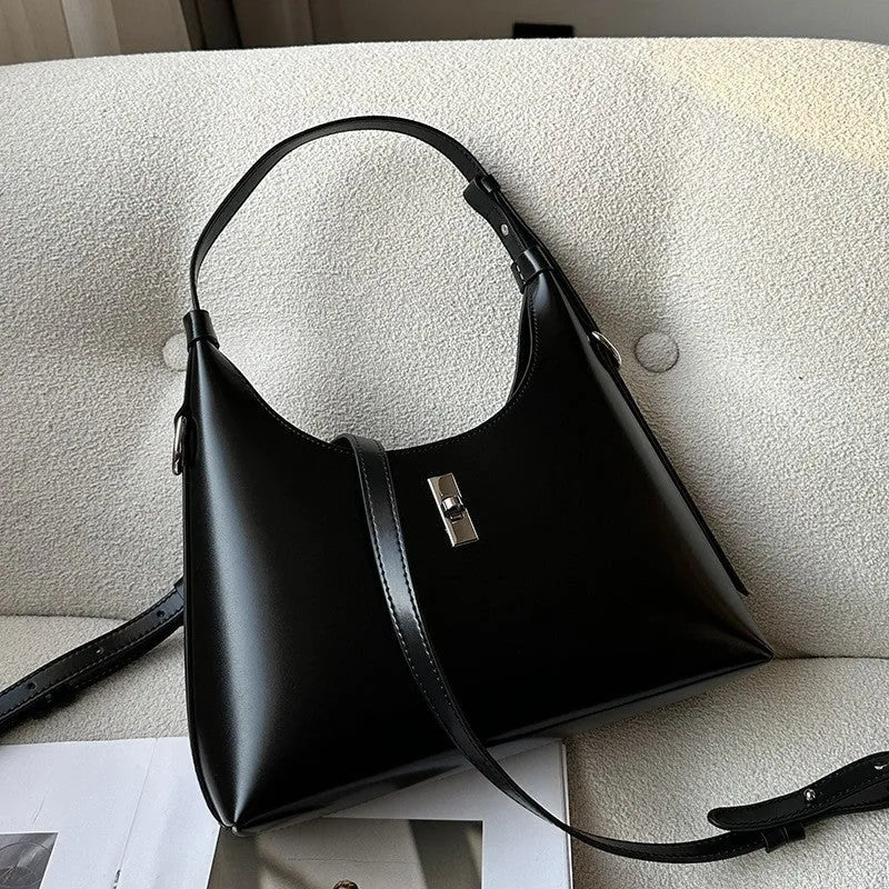 Soft genuine leather dumpling-shaped crossbody shoulder bag in a street style with lock detail