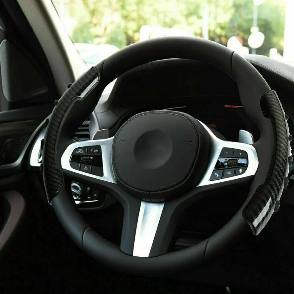 Carbon fibre black fibre anti-skid sleeve on a car steering wheel.
