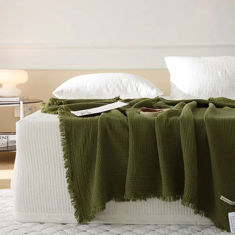 Four-layer gauze cotton blanket with tassel trim in a choice of ten colours and two sizes.