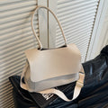 A brown PU tote bag with double shoulder straps and visible sewing thread detail.