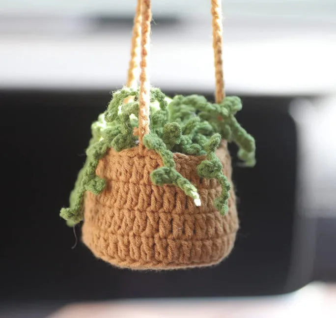 Green and white fish-scale style knitted wool car hanging planter with 8cm base and long white cord.