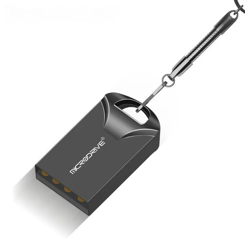 Small black and silver metal USB flash drive showing compact size next to a ruler for scale.