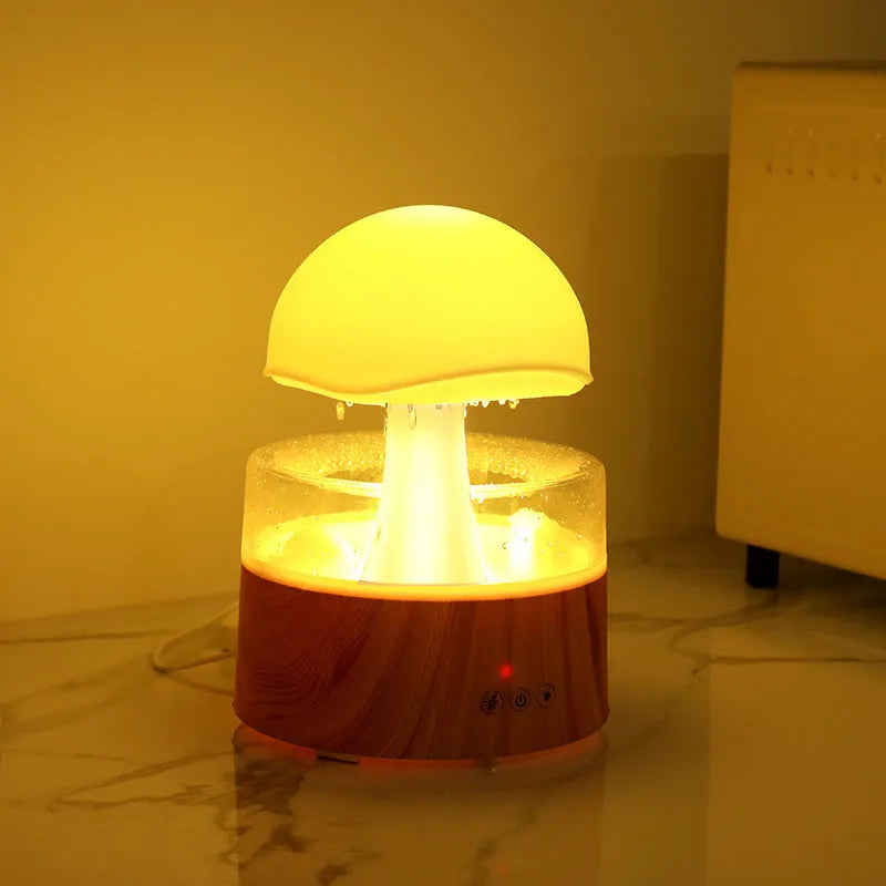 White rain cloud shaped humidifier with falling water droplets and multi-colour lighting