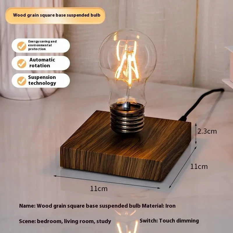 Iron art suspension bulb night lamp on a black wood grain base for desktop decoration.