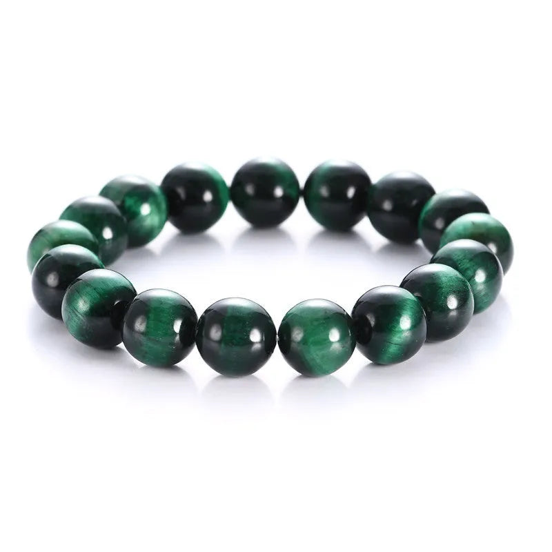 Green Tiger Eye stone geometric bead bracelet on wrist, showing polished surface and banding.