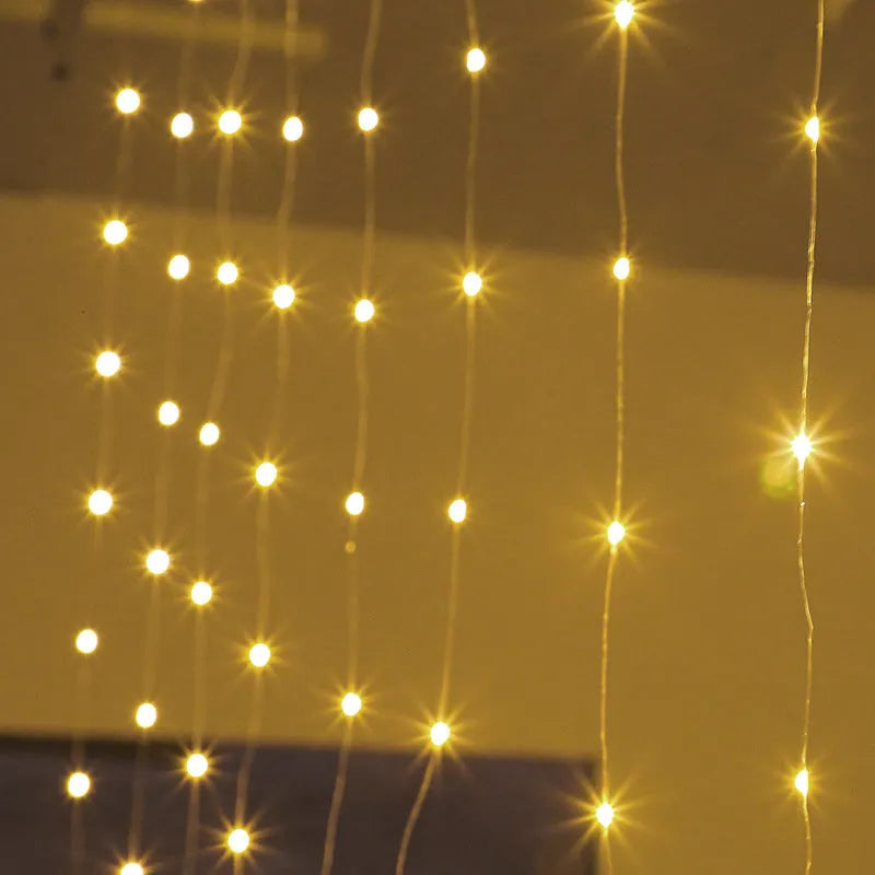 Copper curtain fairy lights with multiple LED beads, showing blue, purple, and white colour options hung in a decorative drape.