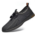 Men's black casual shoes with breathable mesh upper and elastic band closure on a white background.