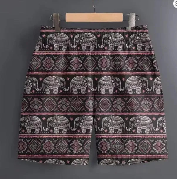 Men's casual polyester shorts in a camouflage pattern, shown in a relaxed outdoor setting.