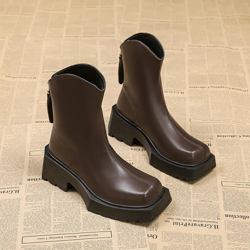 Women's black platform Martin ankle boots with a square toe and back zipper on a white background
