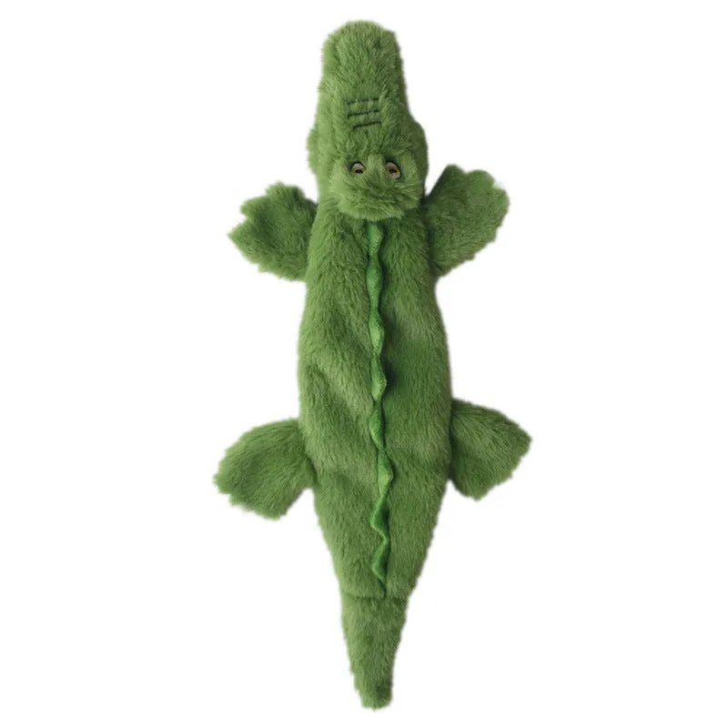 Green crocodile-shaped plush dog toy with no stuffing, squeaker in head, and crinkle paper in tail