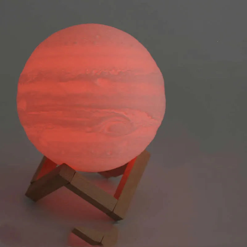 3D printed white moon lamp on wooden stand showing detailed lunar surface texture.