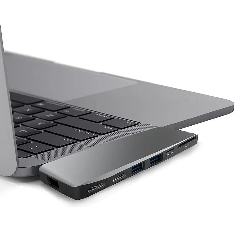 Silver 8-in-1 USB-C hub for MacBook Pro with dual connectors, showing USB, card reader, and charging ports