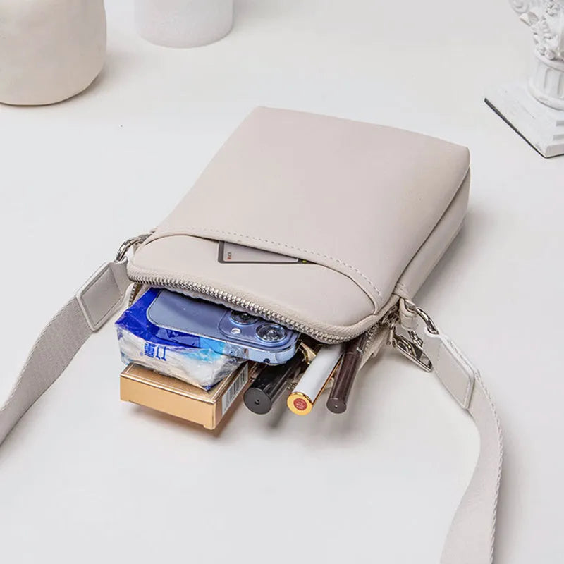 Small solid colour crossbody phone bag for women in beige.