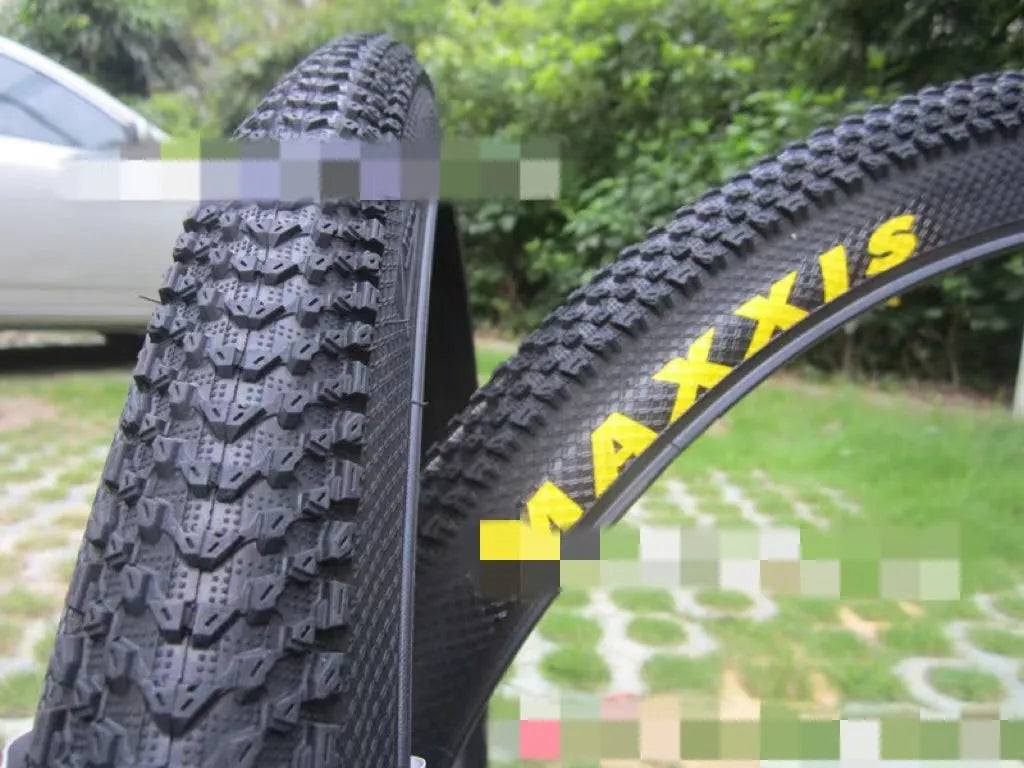 Ultralight puncture-resistant mountain bike tyre shown in black with white label option, for 26, 27.5 and 29-inch wheels.