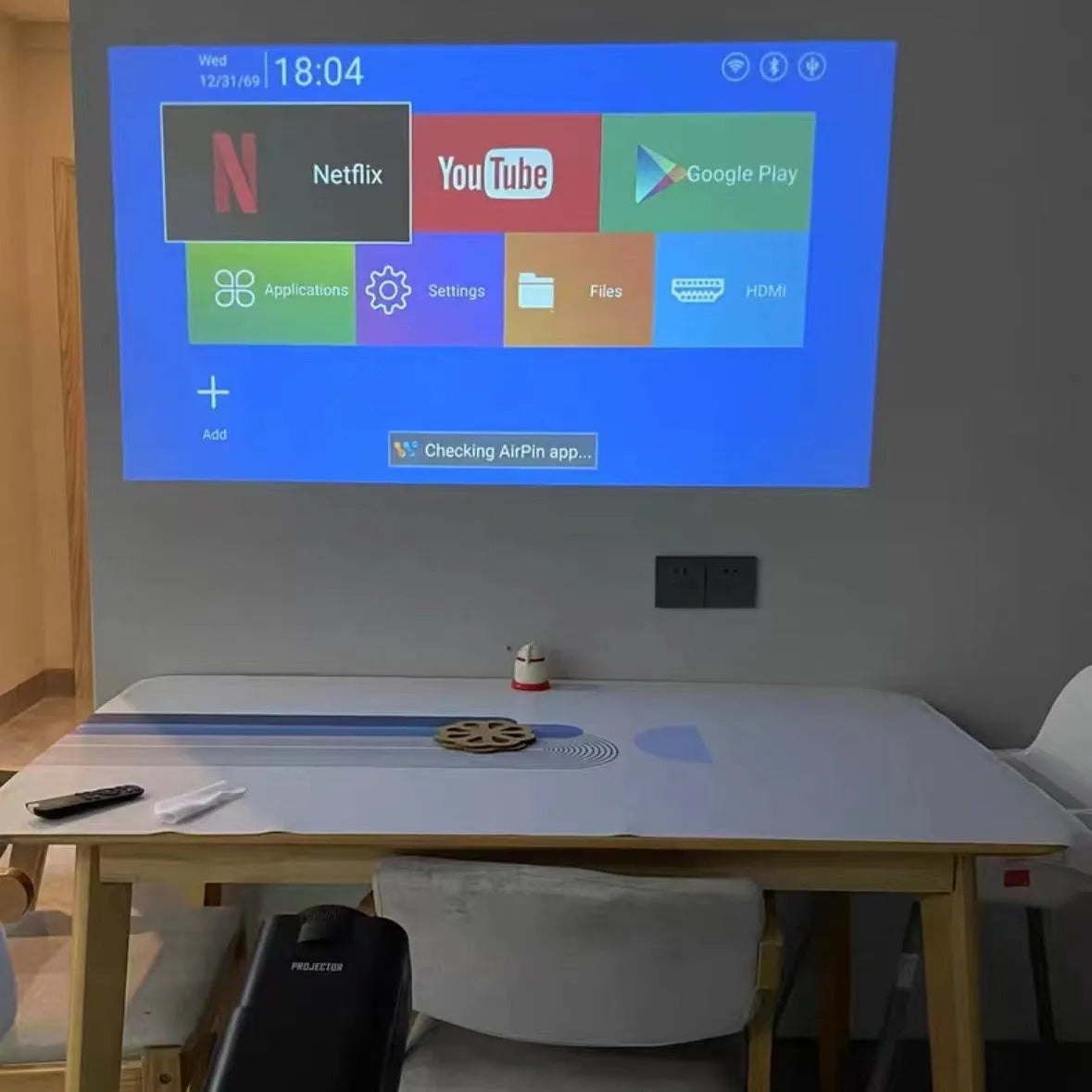 720p wireless home projector with carrying handle on white background