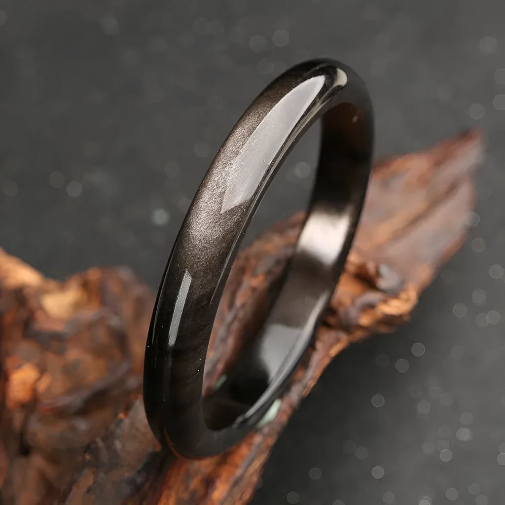 Geometric ethnic obsidian bracelet with a cat's eye gemstone in natural silver stone colour.