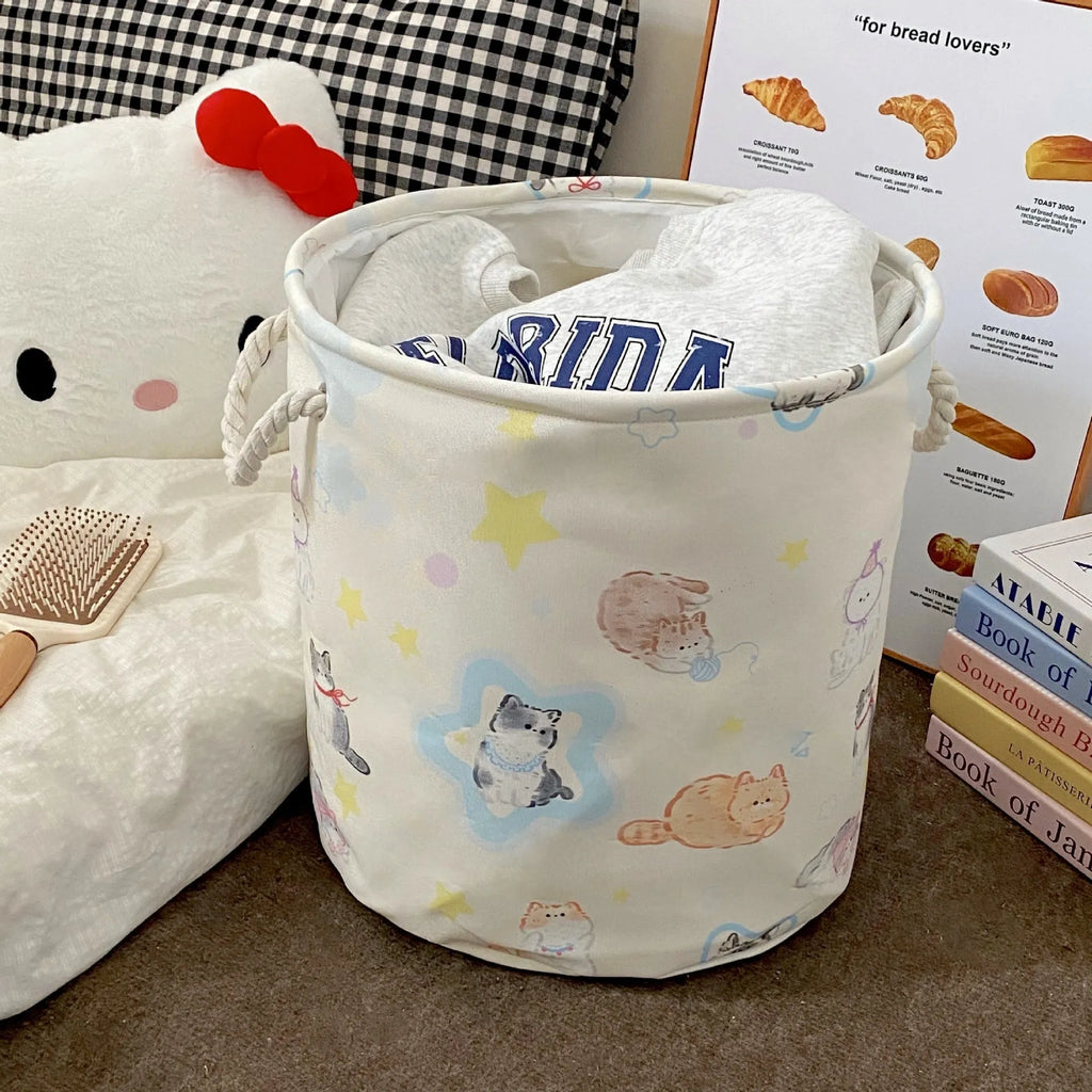 Foldable cotton cloth laundry basket in a character print colour, shown unfolded for use.