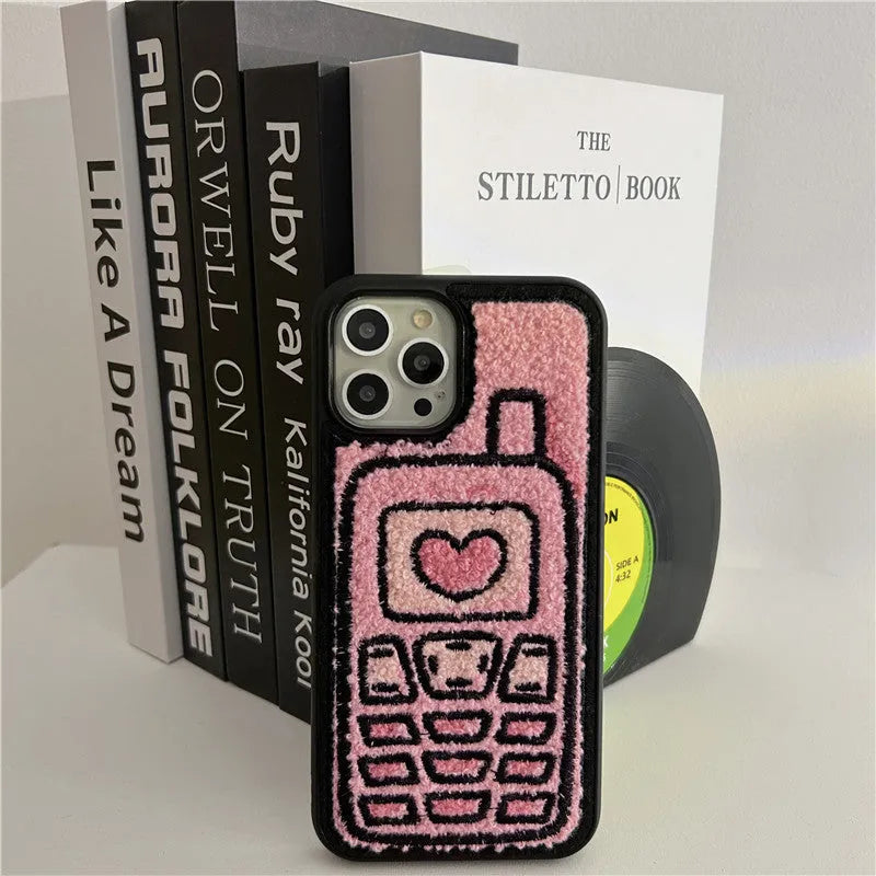 Pink TPU iPhone case with embroidered towel pattern design on the back.