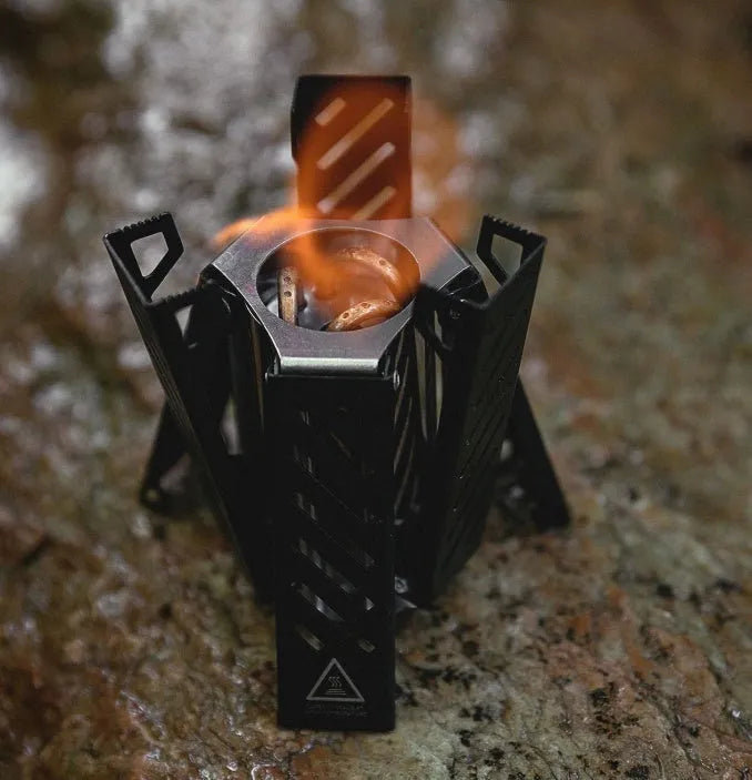 Hexagon alcohol stove folded showing black aluminium alloy construction for camping