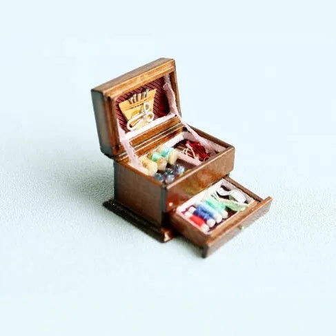 Small vintage sewing machine miniature ornament in a birch wood box with accessories.