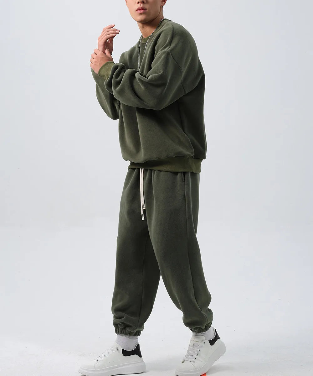 Men's polar fleece sports suit set showing crew neck top with long sleeves and matching padded trousers in winter colours