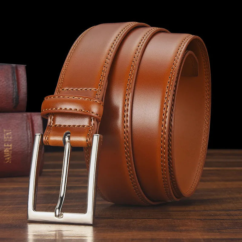 Men's black genuine leather belt with a silver alloy pin buckle shown on a flat surface