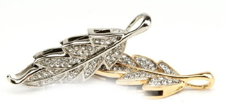 Silver metal USB flash drive with a crystal maple leaf decoration on a white background.
