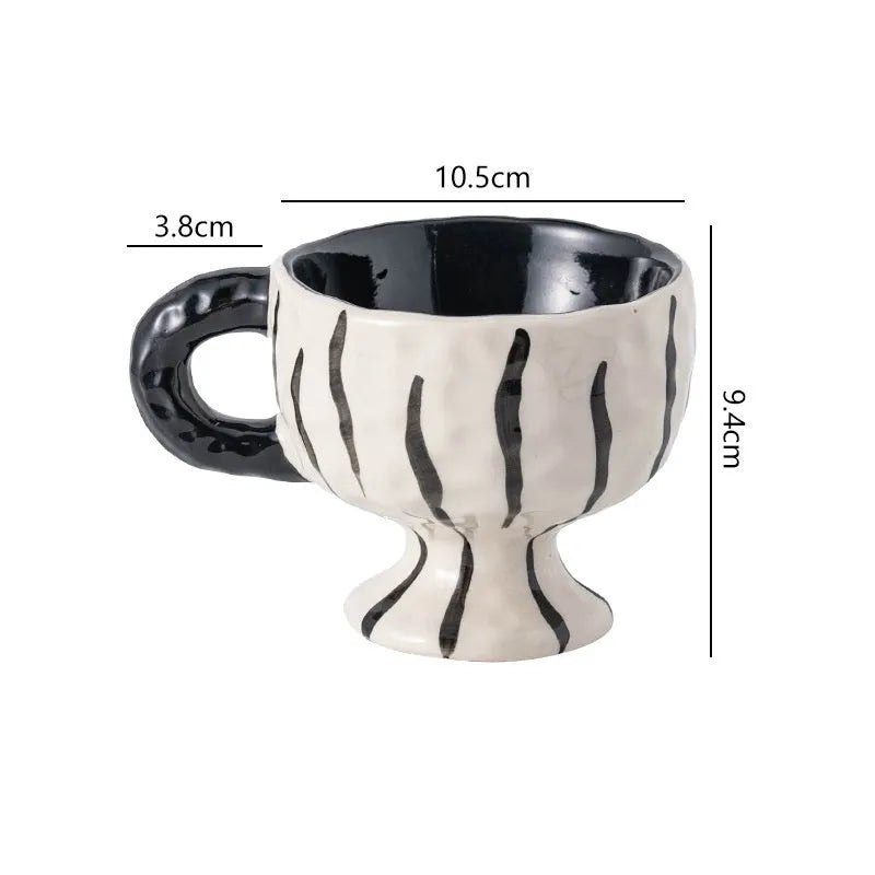 Hand-pinched irregular shaped ceramic mug in a solid colour, modern simple design