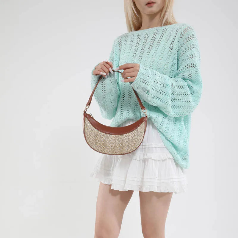 Women's hard straw dumpling-shaped crossbody bag in multiple colours with contrast stitching and internal organiser pockets.