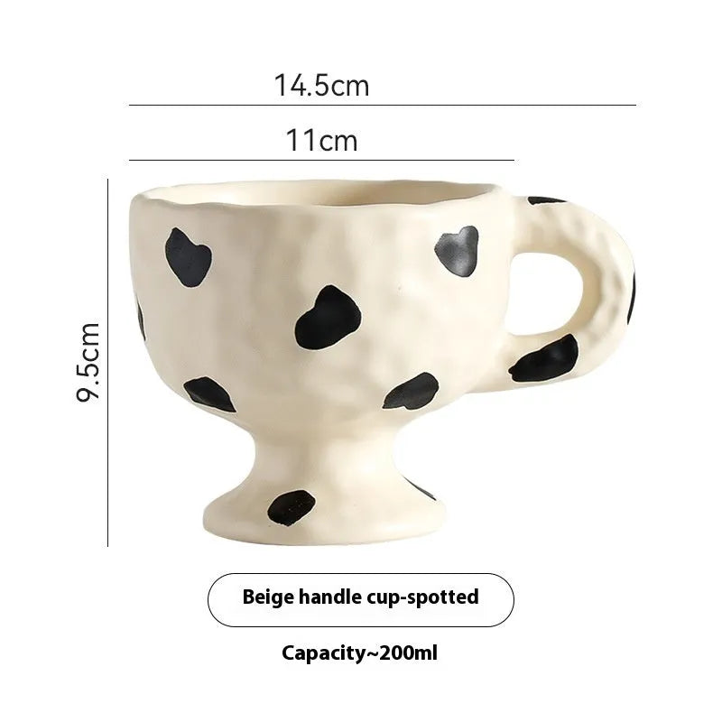 Hand-pinched irregular shaped ceramic mug in a solid colour, modern simple design