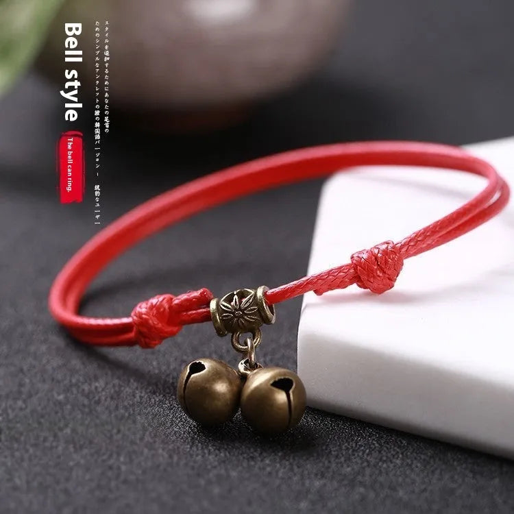 Adjustable nylon rope dog collar with brass bell shown in black, red, and coffee colours for small dogs.