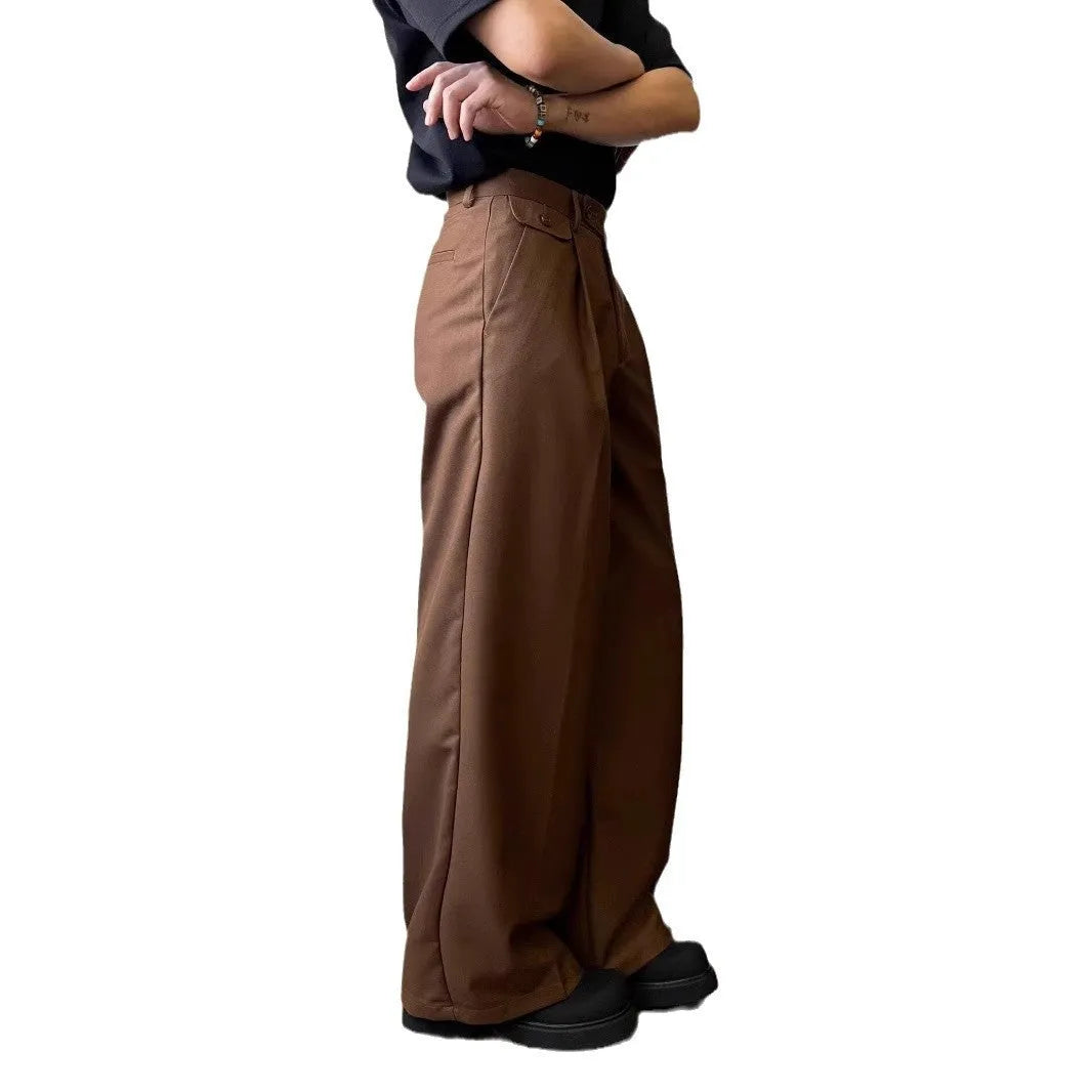 Men's brown straight-leg casual trousers with a loose wide-leg cut on a neutral background.