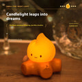 Small cartoon-style night lamp with silicone flame simulation on a table