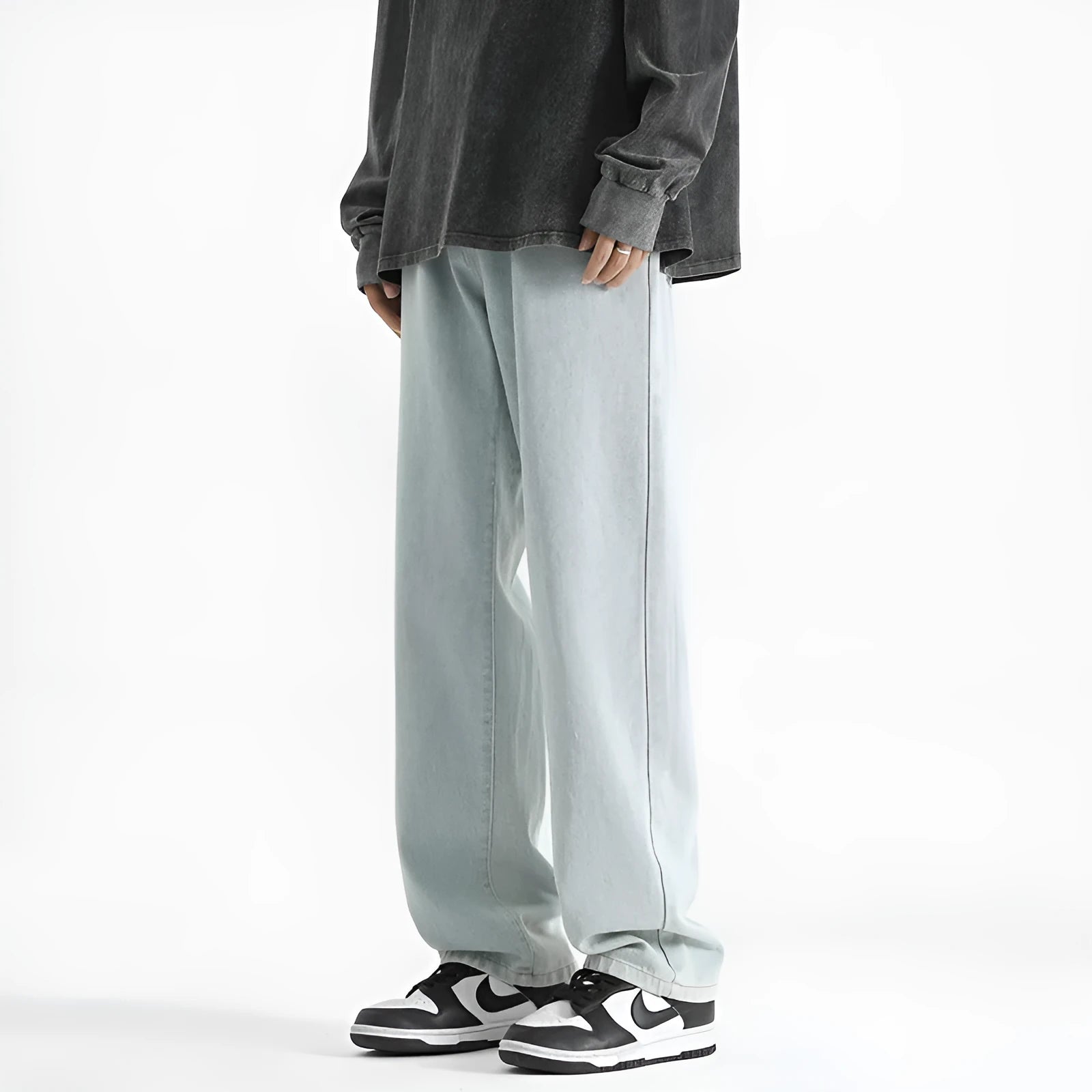 Men's light wash blue straight leg jeans with button fly on a hanger.